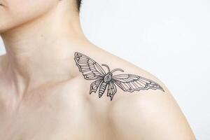 Closeup of a Butterfly Tattoo on a Person's Shoulder photo