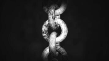 Close up of hanging old rusty chain isolated on a black background. Motion. Rotating old chain links. video