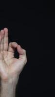 Hand in OK sign on a black isolated background. Everything is in order. video