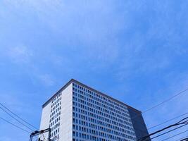 New modern block of flats in residential apartment with flat buildings exterior. Part of City Real estate property and concept. blue sky background. photo