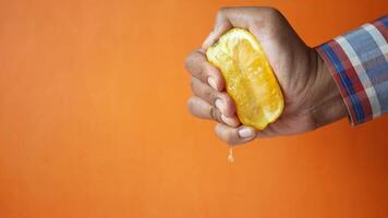 A person holding an orange in their hand video