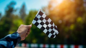 The checkered flag being ped from one hand to the other by the race winner a symbolic gesture of their victory and the start of a new journey as a champion photo