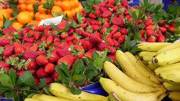 A Vibrant Fresh Fruits Market Display Featuring Delicious Strawberries and Bananas Awaiting You video