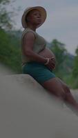 A Pregnant Woman Enjoying a Relaxing Moment Outdoors Surrounded by Beautiful Nature video