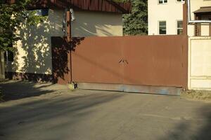 Gate to building. Entrance to territory. Brown fence. photo