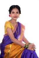 Beautiful Indian young girl posing in traditional Indian saree on white background. photo