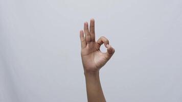 A hand showing okay sign, okay zero fingers gesture isolated on white background video