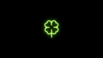 Neon sign in clover shape motion graphic with alpha channel. Green 4 leaf clover neon light turn on and turn off isolated icon animated on transparent background. video