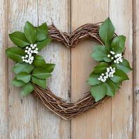 Rustic heart shaped wreath with green leaves and white flowers photo