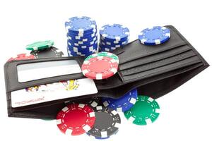 poker chips in black leather purse photo