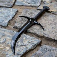 Tactical survival knife on rocky surface photo