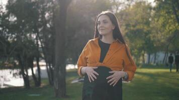 Pregnant Happy Woman outdoors enjoying nature. Pregnant Woman Belly. video