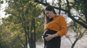 Pregnant Happy Woman outdoors enjoying nature. Mom Expecting her Baby. video