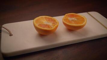 Beautifully Freshly Cut Oranges Arranged Neatly on a Polished Marble Board Surface video