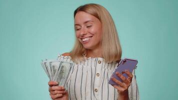 Happy tourist woman use smartphone rejoicing win, receiving money dollar cash, success lottery luck video