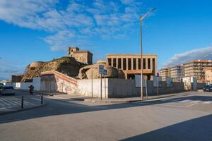 Street Scene in Tarifa, Spain with Castillo de Guzman el Bueno photo