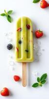 Refreshing fruit popsicle with mixed berries and mint garnished on a white surface photo