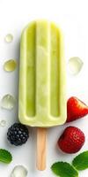 Fresh fruit popsicle on a white background with berries and mint for a refreshing summer treat photo