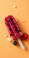 Refreshing berry popsicle with fresh fruits on orange background ready for summer enjoyment photo