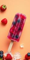 Delicious fruit popsicle on a vibrant orange background with fresh berries scattered around photo