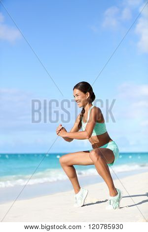 Fitness woman doing bodyweight workout training calves with plie squat calf raise exercise. Asian sport girl doing a ballet inspired ballerina pose to activate glutes and lower body by raising heels.