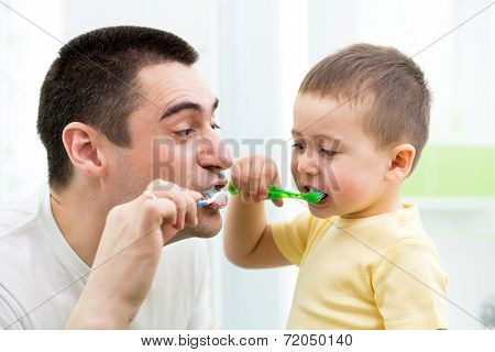 Child Boy And His Dad Brushing Teeth In Bathroom