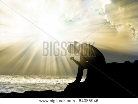 Woman praying to god at sunset