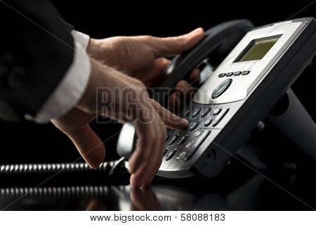 Businessman Dialling Out On A Telephone Call