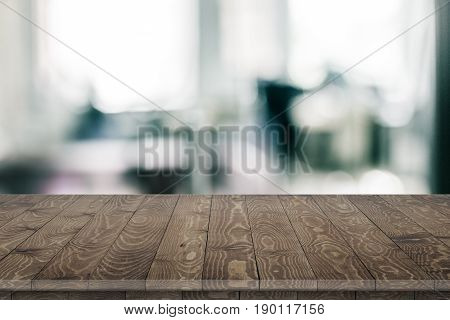 Large office wood table with blurred back. Wood table texture background. Office. Office wood table perspective on blurred office background. Wood table perspective for design. Wood table surface. Rustic wood table perspective on blurred office background