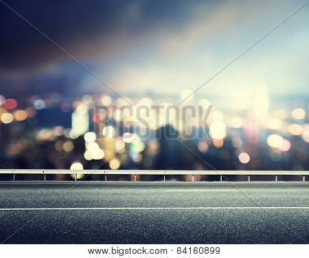 Asphalt road and blurred modern city