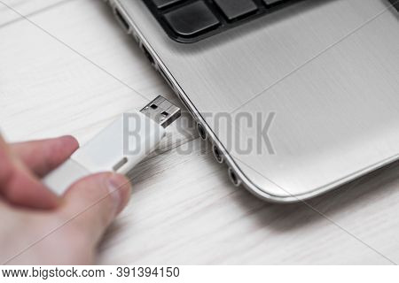 Plugging Removable Flash Disk Memory Into Laptop Usb Slot. Man Hand Inserting Usb Flash Drive Into L