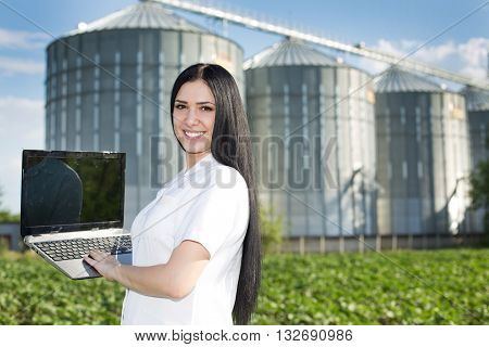 Woman Agronomist In Front Of Silo