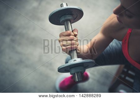 Closeup On Fitness Woman Workout With Dumbbell In Urban Loft Gym