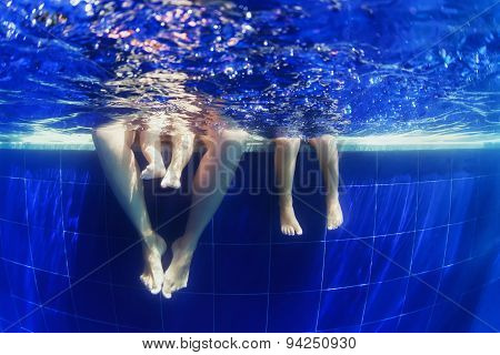 Underwater Photo Of Happy Family Swimming In The Blue Pool