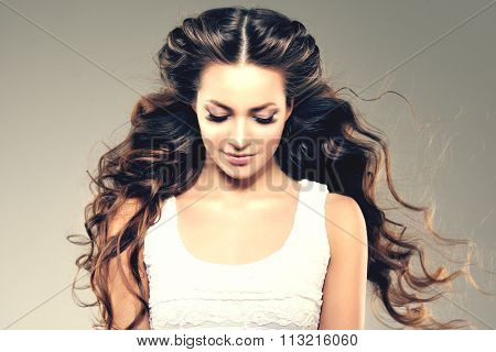 Model with long hair. Waves Curls Hairstyle. Hair Salon. Updo. Fashion model with shiny hair. Woman with healthy hair girl with luxurious haircut. Hair loss Girl with hair volume. 