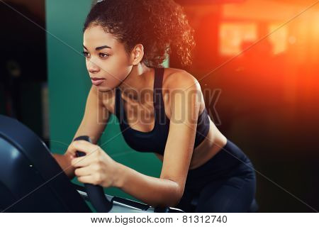 Shot of an attractive young woman at the gym riding on spinning bike with copy space