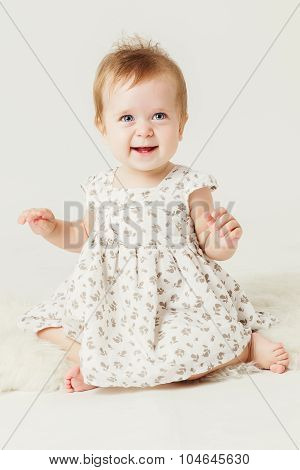 cute little girl smiling sitting on the hide