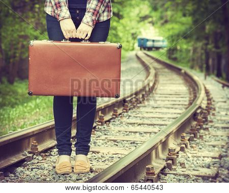 Young Woman With Old Suitcase On Railway