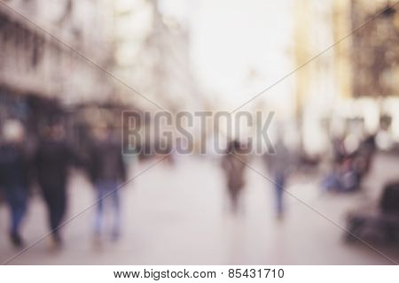 abstract blurred background of people walking in city