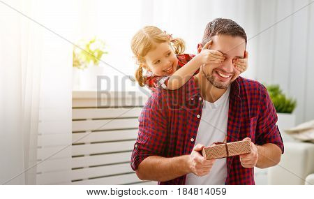 Father's day. Happy family daughter hugging dad and laughs on holiday