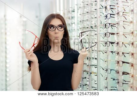 Woman Choosing Eyeglasses Frames in Optical Store - Cute girl deciding for glasses of different shapes and colors