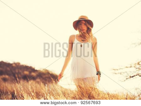 Fashion Lifestyle. Fashion Portrait of Beautiful Young Woman Outdoors. Soft warm vintage color tone. Artsy Bohemian Style.