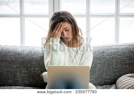 Frustrated Sad Woman Feeling Tired Worried About Problem Sitting On Sofa With Laptop, Stressed Depre