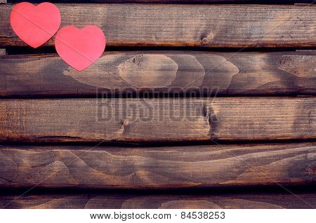 Red heart stickers on a wooden background