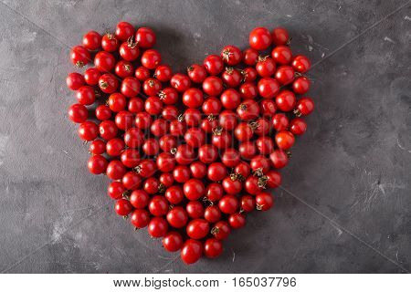 Cherry tomatoes in a hurt form. Colorful tomatoes Tomatoes background. Fresh tomatoes Healthy food concept. Colorful festive still life. Loosely laid tomatoes in different positions.