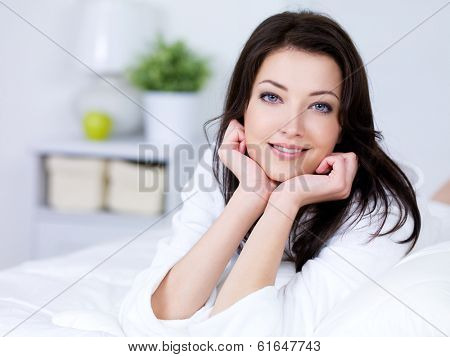 Portrait of beautiful young brunette woman with attractive smile - indoors