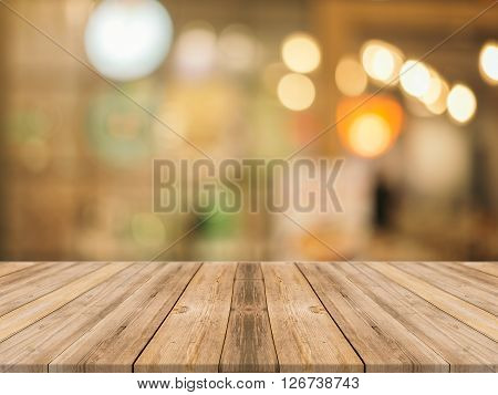 Wooden board empty table in front of blurred background. Perspective brown wood over blur in coffee shop - can be used for display or montage your products.Mock up for display of product.