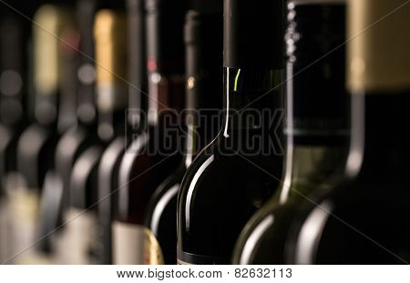 Row of vintage wine bottles in a wine cellar (shallow DOF; color toned image)