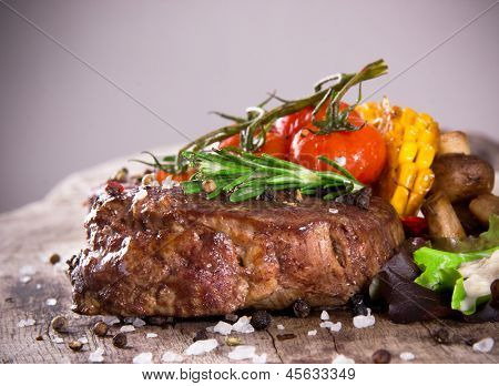 Delicious beef steak on wooden table