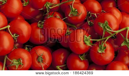 Ripe tasty red tomatoes. Village market organic tomatoes. Fresh tomatoes. Qualitative background from tomatoes.(selective focus)